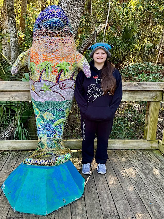 Abby with the Mosaic Manatee Statue on the boardwalk in Blue Springs State Park.