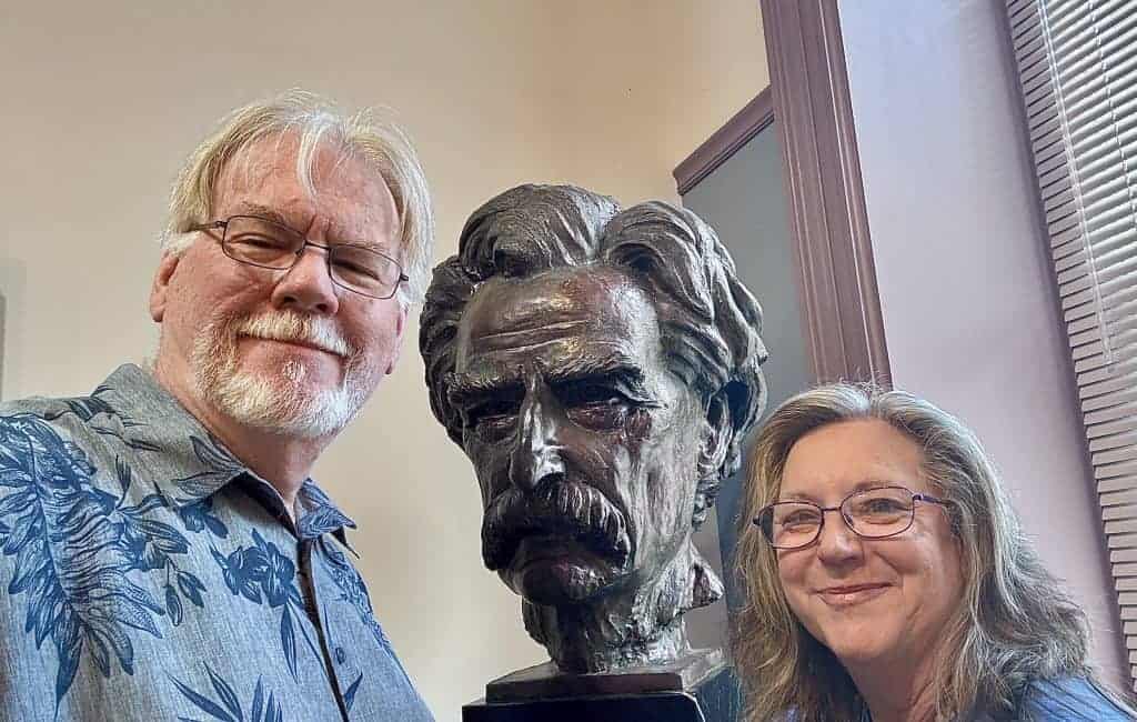Cindy and Jeff next to bust of Samuel Clemens/Mark Twain at the Mark Twain Museum in Hannibal, Missouri.