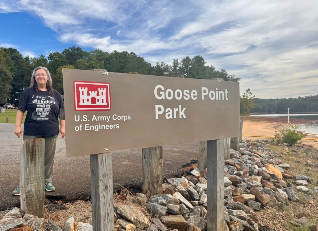 Cindy next to Goose Point Park sign on Philpott Lake October 3, 2026.
